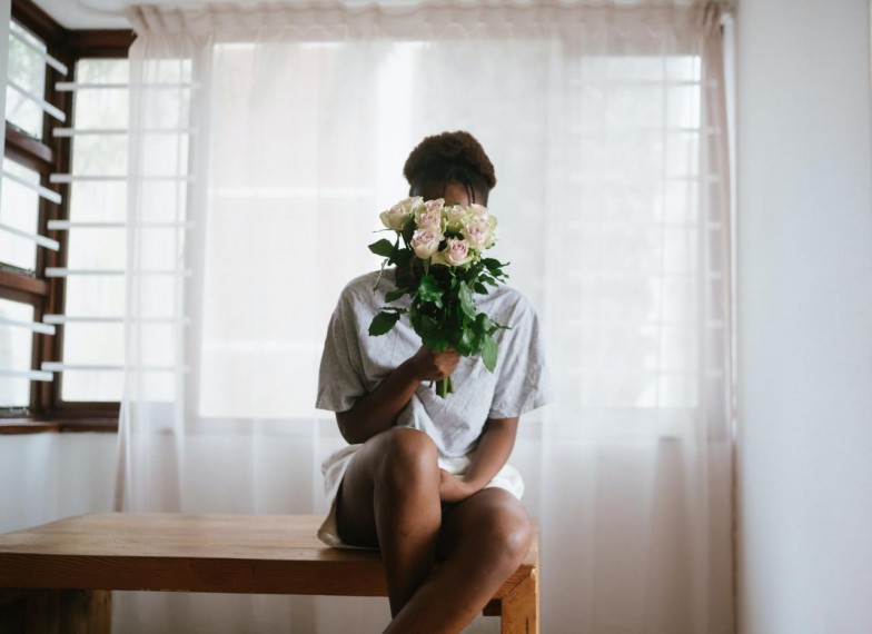 Woman In White Dress Holding White Flower Bouquet