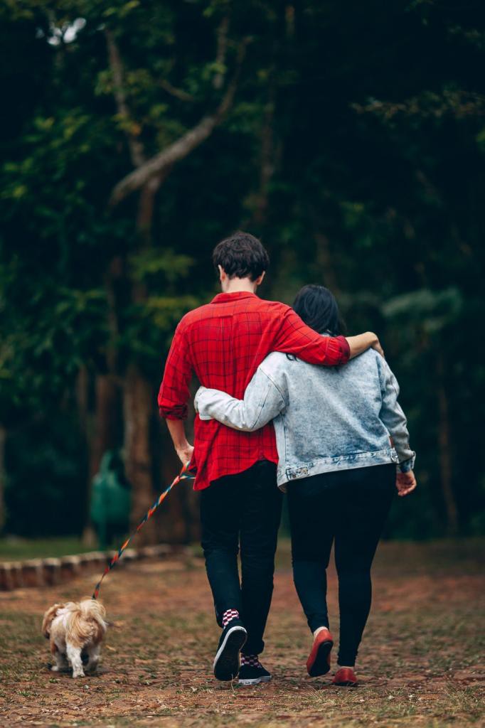 Man and Woman Holding Each Other With Dog