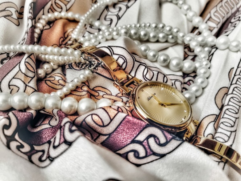 gold and silver round analog watch