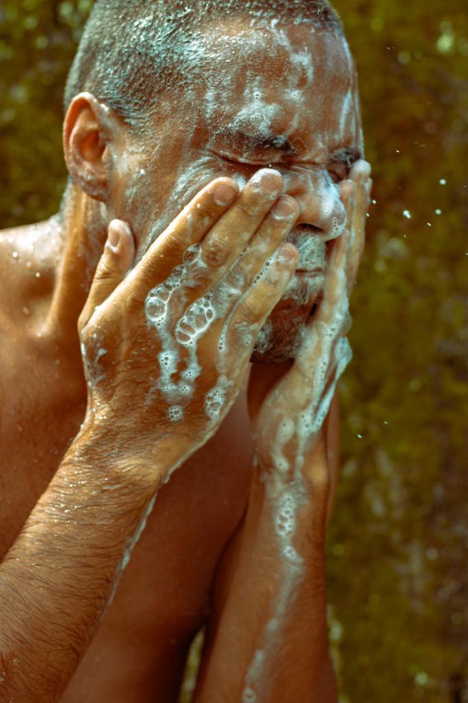 Topless Man Washing His Face