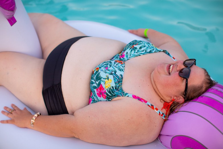 smiling woman on swimming pool floaty photo
