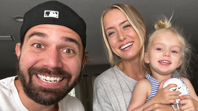 Charles Trippy with wife and daughter smiling at camera