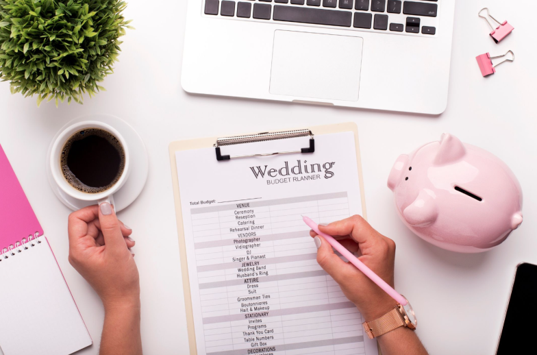Collecting money concept. Woman planning budget before wedding writing ideas on paper