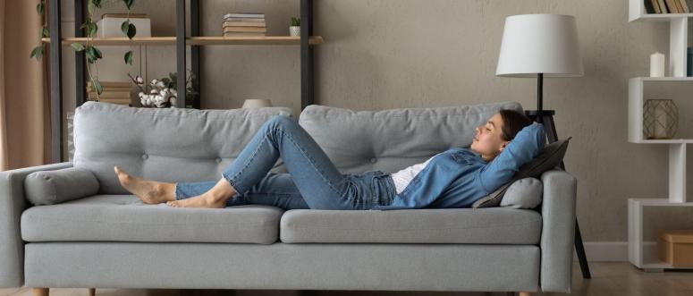 Side view woman enjoy day nap on comfy sofa