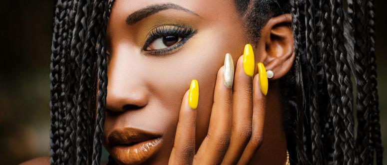 Extreme close up beauty portrait of charming African woman with hand on cheek Extreme close up beauty portrait of charming African woman with hand on cheek
