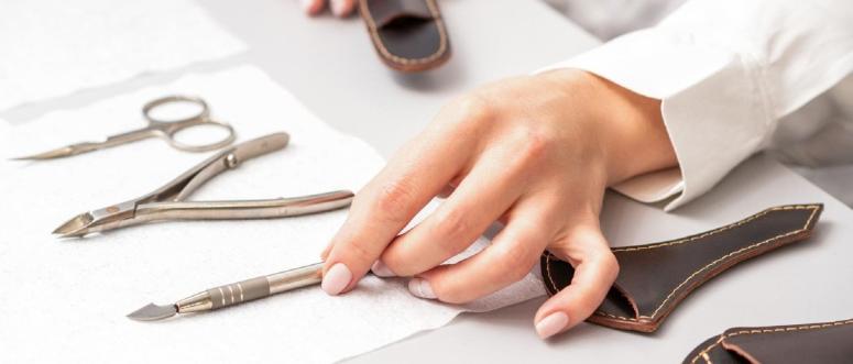 Manicure master lays out manicure set on a towel at the table in a nail salon Manicure master lays out manicure set on a towel at the table in a nail salon