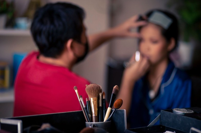 selective focus Make-up converter on makeup artist's table with lots of makeup artist tools. blur background makeup artist doing makeup beautiful girl There is space for text.