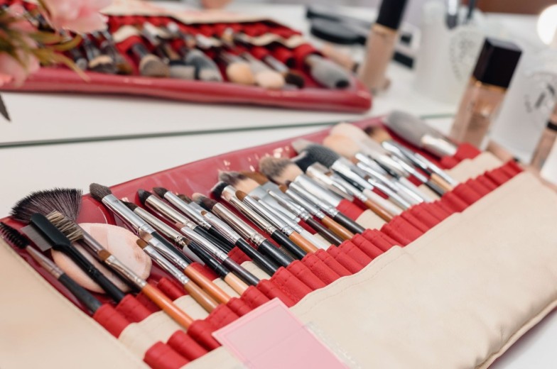 Closeup photo of professional makeup kit with artist tools and beauty products