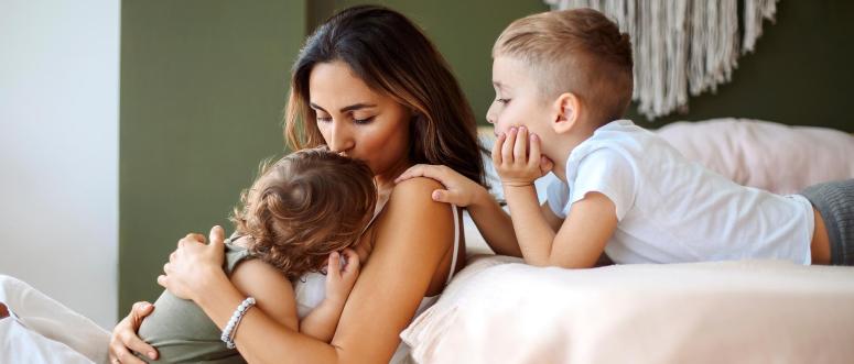 Young family beautiful mother with two son of different ages spending time at home Young family beautiful mother with two son of different ages spending time at home