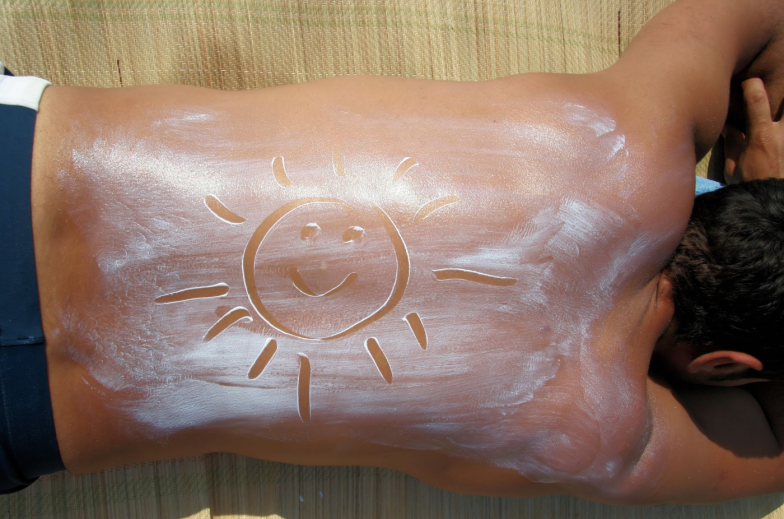 Applying sun cream on the beach