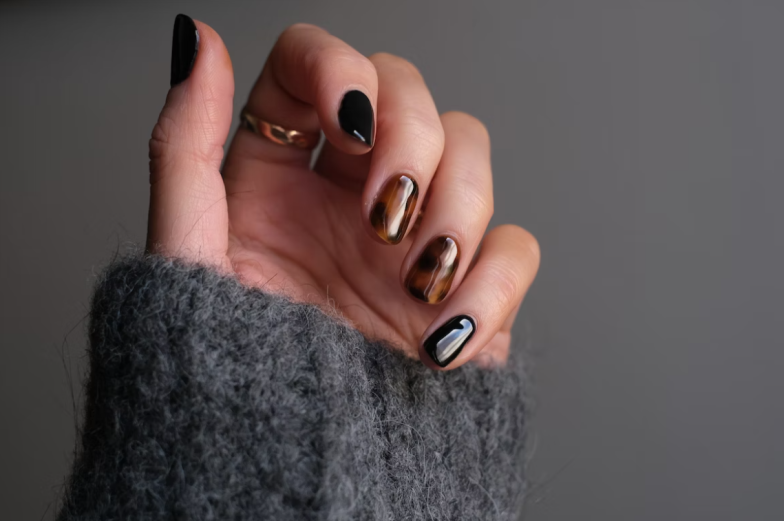Manicure nail paint with thin brush on colour background. Nails artist polish, modelation gel