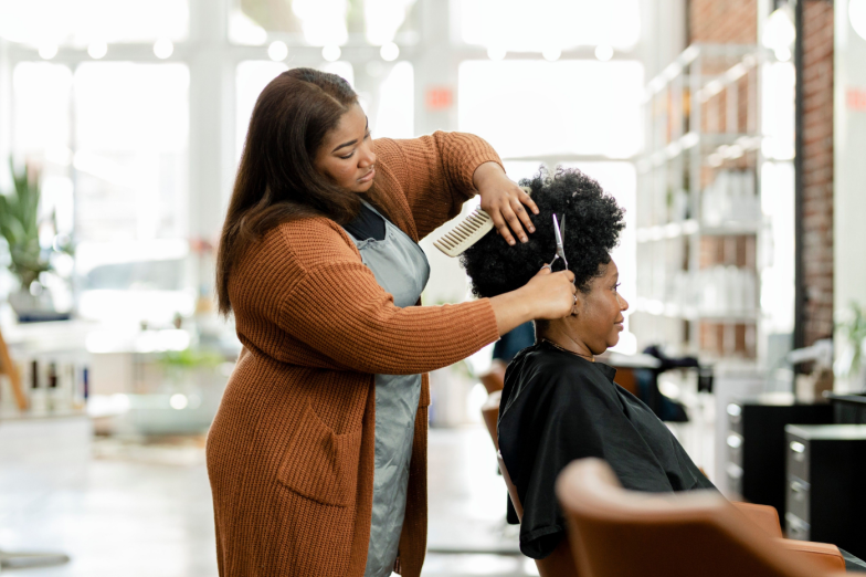 Hairstylist trimming the customer 39;s hair at a beauty salon