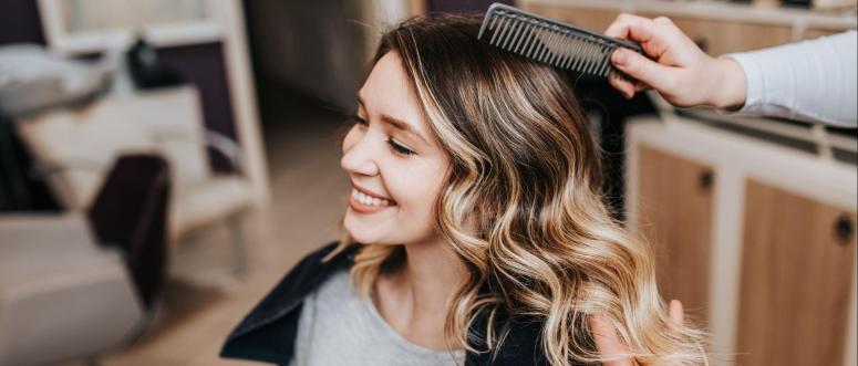 Beautiful hairstyle of young woman after dyeing hair and making highlights in hair salon Beautiful hairstyle of young woman after dyeing hair and making highlights in hair salon