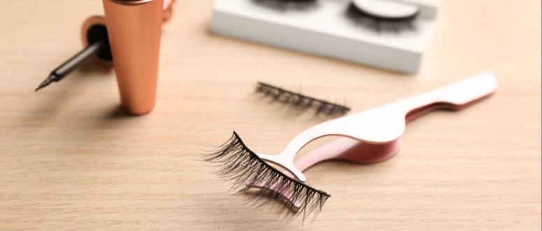 Magnetic eyelashes and accessories on wooden table Magnetic eyelashes and accessories on wooden table