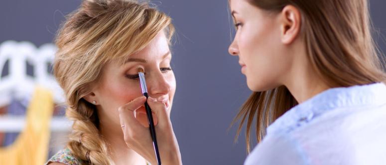 Artist doing professional make up of woman Artist doing professional make up of woman