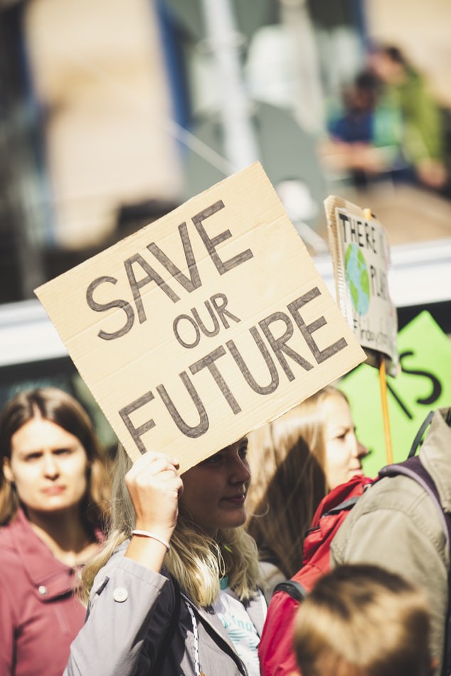 woman holding Save Our Future signage photo