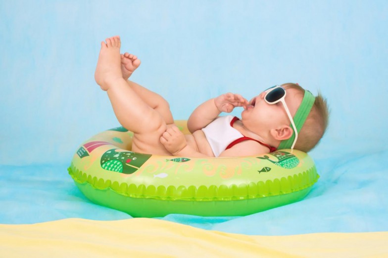 baby lying on inflatable ring photo
