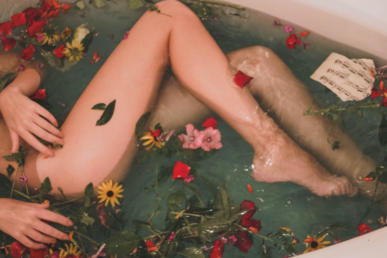 bathtub with water and flowers photo