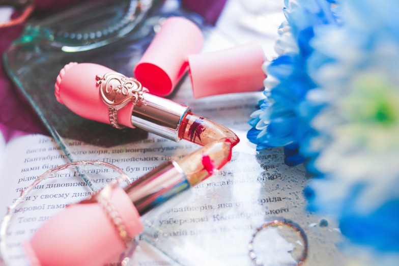 two pink lipsticks on table photo