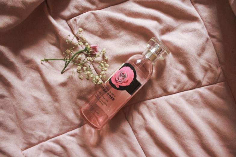 pink perfume bottle on pink textile photo