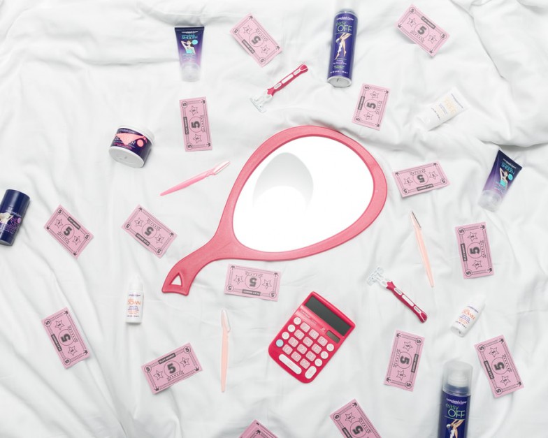 calculator, hand mirror, and toiletries in white textile photo